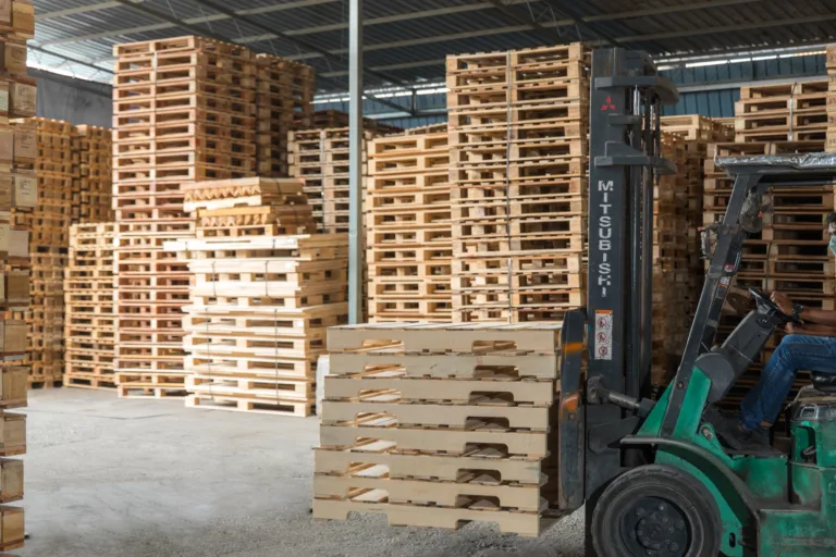 Wooden pallets arranged for forklift handling in warehouse